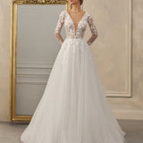 Long-sleeve A-line gown - Plunging neckline bridal dress - Floral lace appliqué dress - Sheer lace sleeves - Fitted bodice - Full tulle skirt - Elegant wedding dress - Formal bridal gown - Timeless beauty gown - Romantic wedding attire