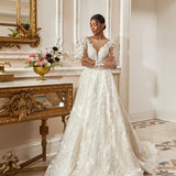 A-line gown - Illusion neckline bridal dress - Long sheer sleeves - Floral lace appliqué dress - Fitted bodice with lace - Flowing tulle skirt - Elegant wedding dress - Formal bridal gown - Romantic wedding attire - Timeless beauty gown