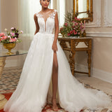 Illusion neckline A-line gown - Plunging V-neck bridal dress - Floral lace appliqué dress - Sheer shoulder details - Fitted bodice with lace - Voluminous skirt with high slit - Elegant wedding dress - Formal bridal gown - Modern sophisticated dress - Timeless beauty gown
