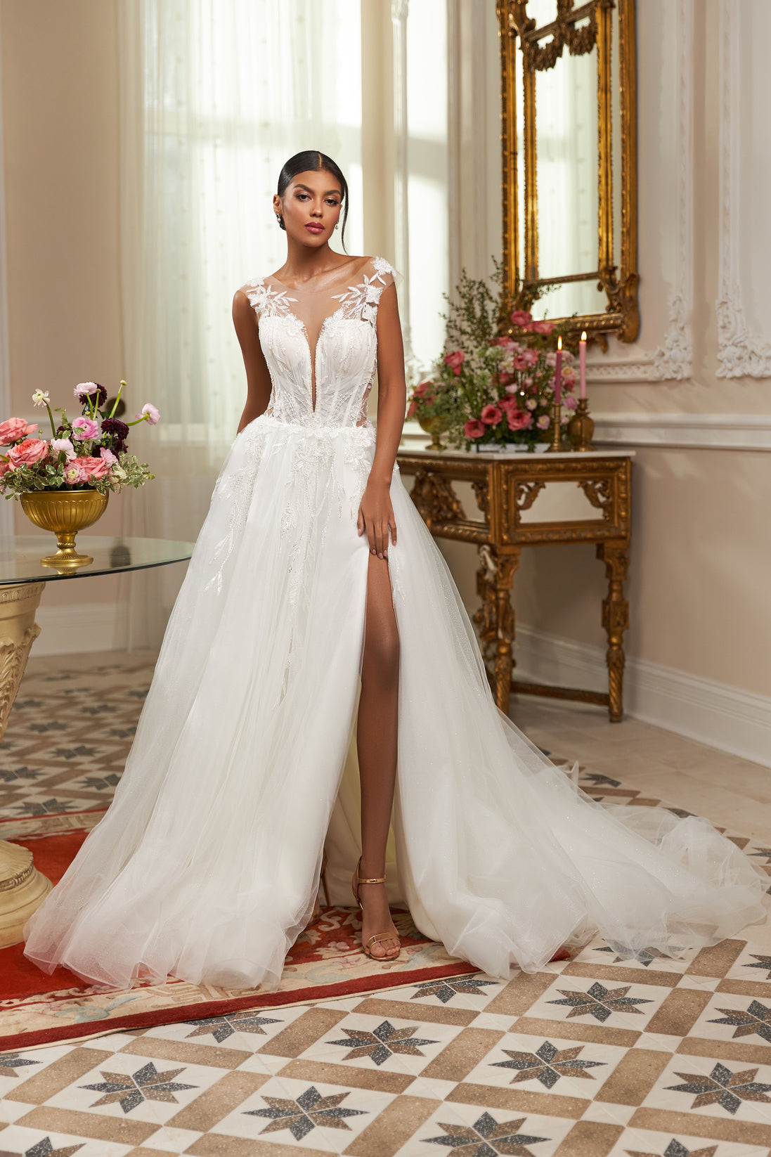 Illusion neckline A-line gown - Plunging V-neck bridal dress - Floral lace appliqué dress - Sheer shoulder details - Fitted bodice with lace - Voluminous skirt with high slit - Elegant wedding dress - Formal bridal gown - Modern sophisticated dress - Timeless beauty gown