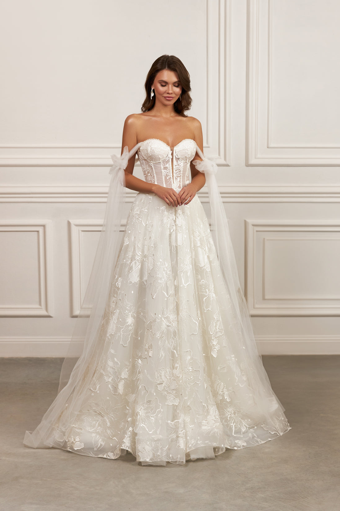 Off-the-shoulder ball gown - Sweetheart neckline bridal dress - Floral lace appliqué dress - Tulle bow sleeves - Structured corset bodice - Full ball gown skirt - Elegant wedding dress - Formal bridal gown - Romantic wedding attire - Timeless beauty gown