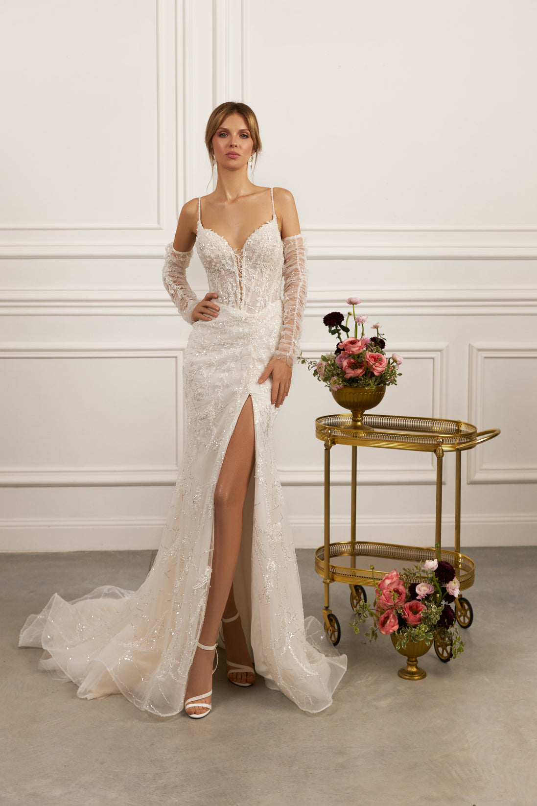 Sheath gown - Plunging neckline bridal dress - Sheer illusion sleeves - Lace appliqué dress - Spaghetti strap wedding gown - Fitted bodice with lace - High slit skirt - Elegant wedding dress - Formal bridal gown - Modern sophisticated dress