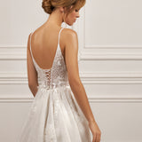 Sleeveless A-line gown - Plunging neckline bridal dress - Floral appliqué dress - Spaghetti strap wedding gown - Fitted bodice with lace - Shimmering A-line skirt - Elegant wedding dress - Formal bridal gown - Contemporary style dress - Classic elegance gown