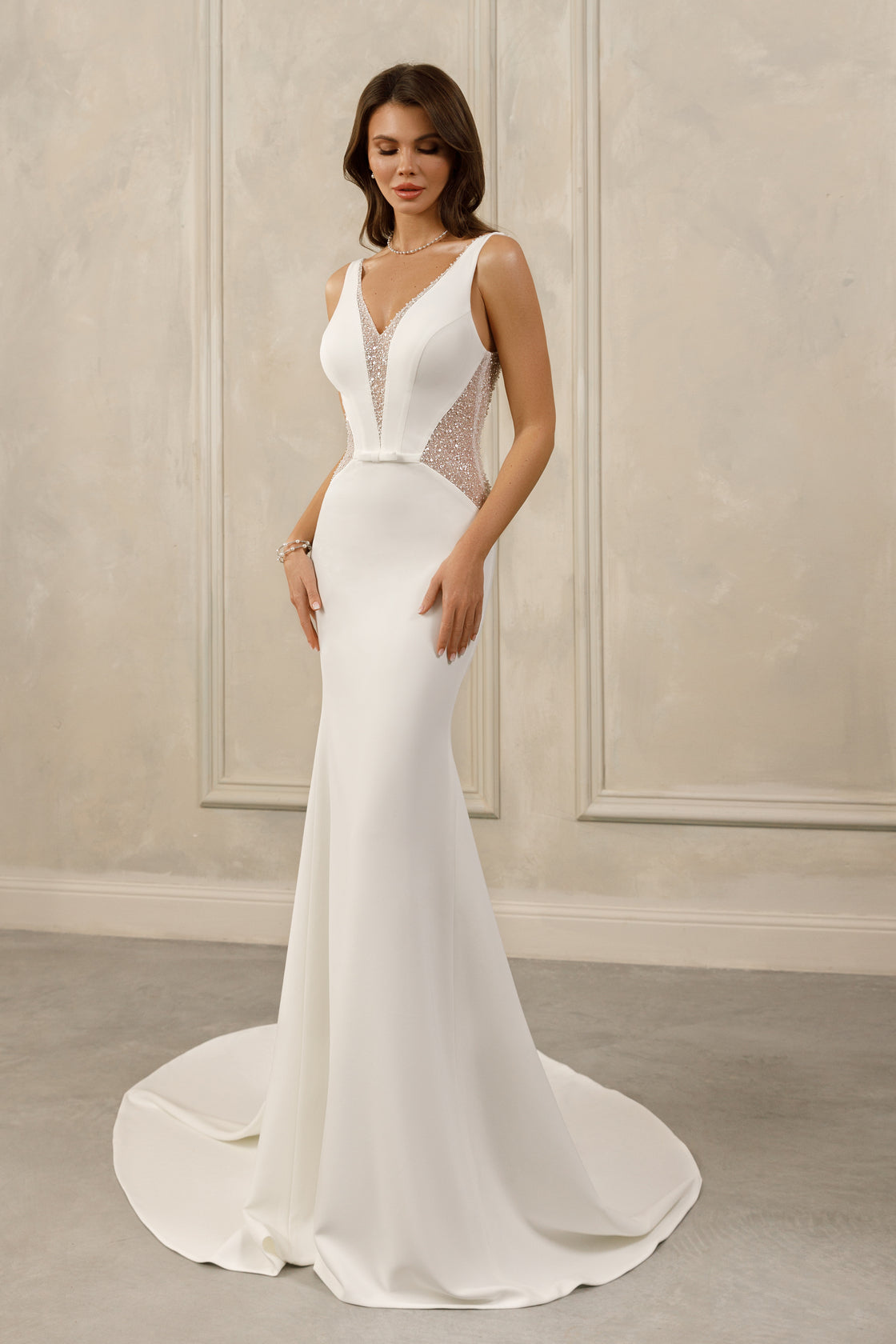 Sleeveless sheath gown - Deep V-neck bridal dress - Glittering illusion panels - Fitted bodice with beading - Minimalist wedding dress - Elegant sheath silhouette - Sophisticated evening dress - Modern bridal gown - Sleek and glamorous dress - Special occasion gown