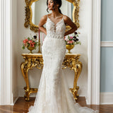 Sleeveless mermaid gown - Plunging neckline bridal dress - Lace and bead embellished dress - Spaghetti strap wedding gown - Fitted bodice with lace - Mermaid silhouette dress - Elegant wedding dress - Formal bridal gown - Modern sophisticated dress - Timeless beauty gown