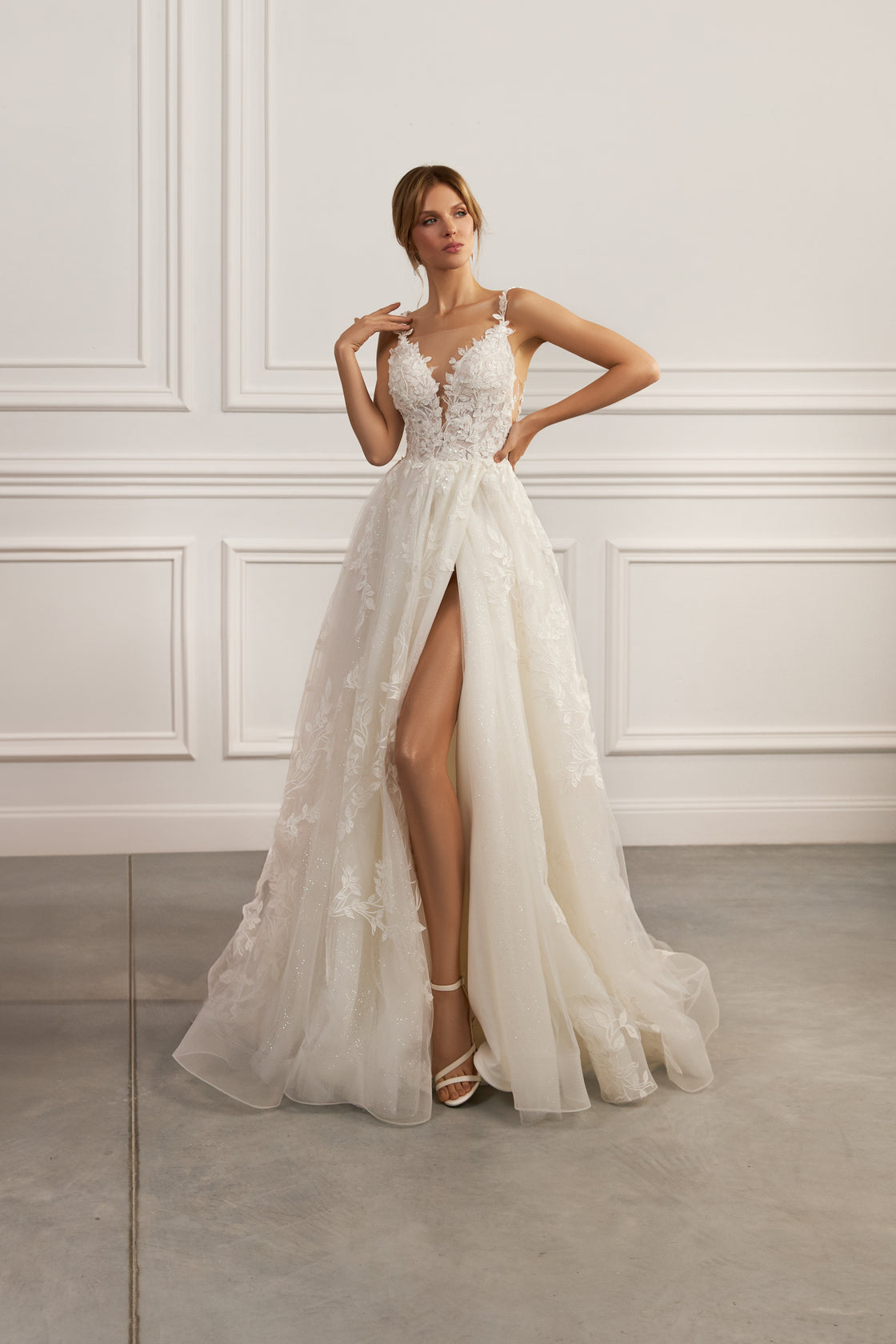 Sleeveless V-neck gown - Floral lace appliqué dress - Plunging neckline gown - Fitted bodice dress - A-line skirt with high slit - Elegant wedding dress - Formal evening dress - Special occasion gown - Timeless beauty dress - Dramatic high slit dress